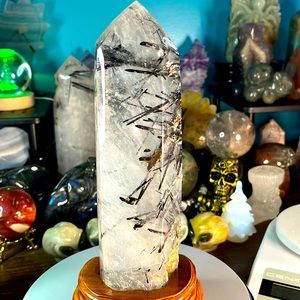 9” rutilated quartz tower with custom stand. 2.18 lbs including stand.